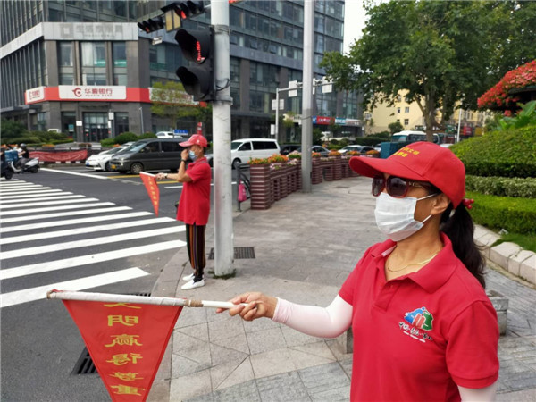 青島市北區(qū)敦化路街道公共文明引導志愿者為創(chuàng)城添光彩